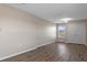 A bright bedroom with wood-look flooring, a window, a closet, and modern lighting at 13619 Hunters Point St, Spring Hill, FL 34609