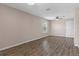 Spacious bedroom with wood-look floors, neutral paint, and a ceiling fan for added comfort and style at 13619 Hunters Point St, Spring Hill, FL 34609