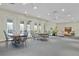 Spacious clubhouse featuring tables, chairs, and a cozy lounge area for residents' enjoyment and relaxation at 13619 Hunters Point St, Spring Hill, FL 34609
