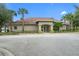 The front of the community clubhouse, featuring a well-manicured landscape and a welcoming entrance at 13619 Hunters Point St, Spring Hill, FL 34609