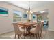 Staged dining room featuring large window and view to living room at 13619 Hunters Point St, Spring Hill, FL 34609