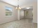 Dining room with decorative chandelier and view to separate living room at 13619 Hunters Point St, Spring Hill, FL 34609