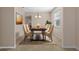 Staged dining room showcasing table with seating for six and decorative rug at 13619 Hunters Point St, Spring Hill, FL 34609