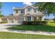 Charming two-story home showcasing a well-manicured lawn and a three-car garage at 13619 Hunters Point St, Spring Hill, FL 34609