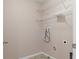 An empty laundry room featuring tile flooring and wire shelving, ready for customization at 13619 Hunters Point St, Spring Hill, FL 34609