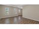 This living room features wood-look floors and plenty of windows at 13619 Hunters Point St, Spring Hill, FL 34609