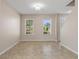 Bright living room featuring tile flooring, two windows and neutral walls at 13619 Hunters Point St, Spring Hill, FL 34609