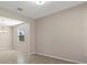 Bright living room with neutral walls, tiled floors, and a large window at 13619 Hunters Point St, Spring Hill, FL 34609