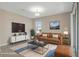 Virtually staged living room featuring a sofa, TV, coffee table and modern decor at 13619 Hunters Point St, Spring Hill, FL 34609