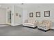 Inviting lounge space with neutral-toned furniture, decorative pillows, and artwork, creating a cozy atmosphere at 13619 Hunters Point St, Spring Hill, FL 34609