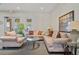 Comfortable lounge area in the clubhouse, featuring plush seating, a glass coffee table, and ample natural light at 13619 Hunters Point St, Spring Hill, FL 34609