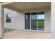 Covered patio featuring sliding glass doors leading into the home and a window providing natural light and a view of the backyard at 13619 Hunters Point St, Spring Hill, FL 34609