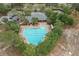 Aerial view of a large community pool with lounge chairs and well-maintained landscaping at 13619 Hunters Point St, Spring Hill, FL 34609