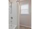 Bathroom featuring a mosaic tiled shower and chrome hardware, for a modern aesthetic at 13619 Hunters Point St, Spring Hill, FL 34609