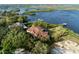 A luxury home featuring a tile roof, mature landscaping, and waterfront access at 1473 Sail Harbor Cir, Tarpon Springs, FL 34689