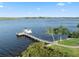 Aerial view of boat dock and lift on water with clear blue sky in the background at 1473 Sail Harbor Cir, Tarpon Springs, FL 34689