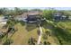 Aerial view of the backyard featuring a screened-in patio, and brick path at 1473 Sail Harbor Cir, Tarpon Springs, FL 34689