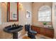 Charming powder room with a unique blue pedestal sink and matching toilet, accented by elegant wallpaper at 1473 Sail Harbor Cir, Tarpon Springs, FL 34689