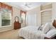 Cozy bedroom featuring a double bed with white quilt and decorative pillows, complemented by large windows and built-in shelves at 1473 Sail Harbor Cir, Tarpon Springs, FL 34689