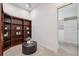 A spacious closet features custom shelving and a dark wood bookcase with decor on display at 1473 Sail Harbor Cir, Tarpon Springs, FL 34689