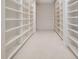 Expansive walk-in closet featuring custom built-in shelving offering lots of storage space at 1473 Sail Harbor Cir, Tarpon Springs, FL 34689
