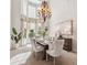 Airy dining room with a soaring window, chandelier, and a table set for a meal at 1473 Sail Harbor Cir, Tarpon Springs, FL 34689