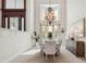 Bright dining room featuring large windows, elegant chandelier, and neutral decor at 1473 Sail Harbor Cir, Tarpon Springs, FL 34689