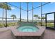 Screened patio with hot tub and views of the water at 1473 Sail Harbor Cir, Tarpon Springs, FL 34689