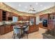 Bright kitchen with wooden cabinets, central island with seating, and stainless steel appliances at 1473 Sail Harbor Cir, Tarpon Springs, FL 34689