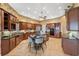 Open-concept kitchen featuring dark wooden cabinets, central island, and modern appliances at 1473 Sail Harbor Cir, Tarpon Springs, FL 34689