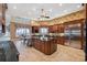Large kitchen with central island, wooden cabinets, stainless steel appliances, and tiled floor at 1473 Sail Harbor Cir, Tarpon Springs, FL 34689
