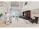 Elegant living room featuring soaring ceilings, french doors, and decorative wall paper, blending style and comfort at 1473 Sail Harbor Cir, Tarpon Springs, FL 34689