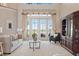 Charming living room featuring french doors with water views, and a display cabinet for added elegance at 1473 Sail Harbor Cir, Tarpon Springs, FL 34689