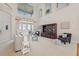 Elegant living room featuring soaring ceilings, a built-in display cabinet, and french doors with water views at 1473 Sail Harbor Cir, Tarpon Springs, FL 34689