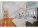 Bright and spacious living room with soaring ceilings, staircase and french doors offering water views at 1473 Sail Harbor Cir, Tarpon Springs, FL 34689