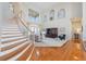 Inviting living room with a staircase, soaring ceilings, and decoratively painted recessed architectural features at 1473 Sail Harbor Cir, Tarpon Springs, FL 34689