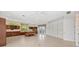 Spacious living room featuring built-in cabinets, shelving and bright windows with a seating area at 1473 Sail Harbor Cir, Tarpon Springs, FL 34689