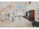 Elegant living room featuring a large staircase, soaring ceilings, and french doors with water views at 1473 Sail Harbor Cir, Tarpon Springs, FL 34689