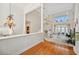 Bright and spacious living room with soaring ceilings, hardwood floors, staircase and water views at 1473 Sail Harbor Cir, Tarpon Springs, FL 34689