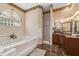 Elegant main bathroom with a soaking tub, shower, and dual vanities at 1473 Sail Harbor Cir, Tarpon Springs, FL 34689