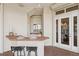 Covered outdoor bar area with sink, tiled countertop, and access to home's interior at 1473 Sail Harbor Cir, Tarpon Springs, FL 34689