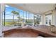 Screened patio with outdoor seating, kitchen, and spa overlooking beautiful waterfront at 1473 Sail Harbor Cir, Tarpon Springs, FL 34689