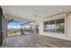 Screened patio featuring tile floors, ceiling fan, and views of the water at 1473 Sail Harbor Cir, Tarpon Springs, FL 34689