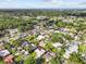 An aerial view of a neighborhood highlighting a charming home surrounded by lush greenery at 155 Patty Ann Blvd, Palm Harbor, FL 34683