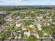 Aerial view of a charming home in a serene neighborhood with lush greenery and nearby water views at 155 Patty Ann Blvd, Palm Harbor, FL 34683