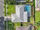 Aerial view of home with nice roof, backyard pool, patio, manicured lawn and fence at 155 Patty Ann Blvd, Palm Harbor, FL 34683
