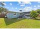 View of backyard, pool, well-manicured lawn, patio, and fenced yard for added privacy at 155 Patty Ann Blvd, Palm Harbor, FL 34683
