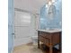 Bathroom with blue walls, wood-look floors, and a wood vanity at 155 Patty Ann Blvd, Palm Harbor, FL 34683