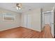 Bedroom with wood flooring, a ceiling fan, and a double-door closet for storage at 155 Patty Ann Blvd, Palm Harbor, FL 34683