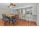 Open-concept dining room and bar with modern wood floors and lighting at 155 Patty Ann Blvd, Palm Harbor, FL 34683